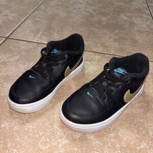 Nike Kids Black Sneakers with Gold Swoosh and Teal Accents